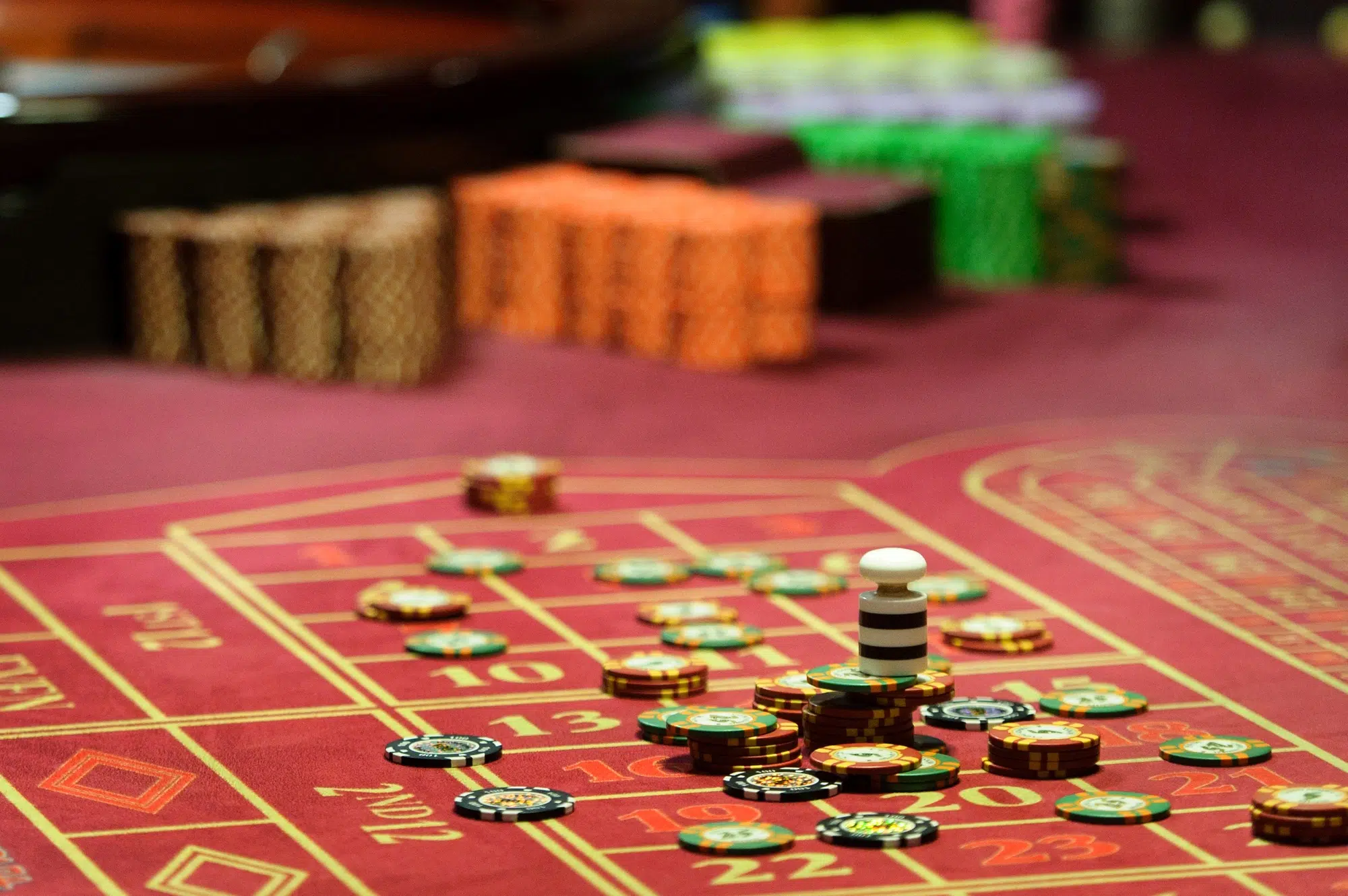 close-up of casino chips on the red table