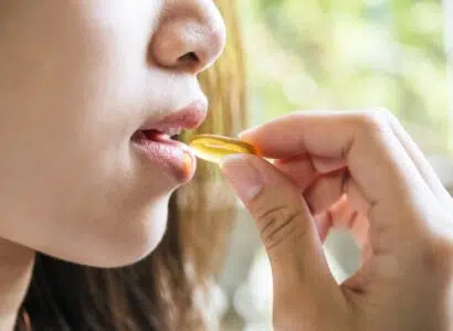Young woman taking medicine pill after doctor order